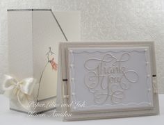 a wedding card with the word thank you on it next to an envelope and bow