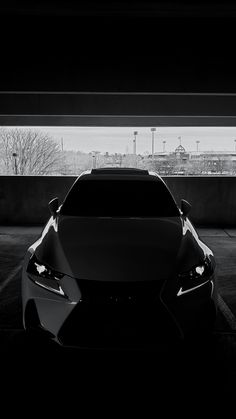 a black and white photo of a car in a parking lot