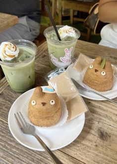 two desserts are sitting on plates with forks and spoons in front of them