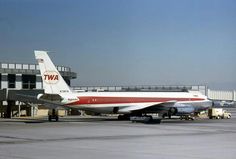 an airplane is parked on the tarmac at an airport with another plane in the background