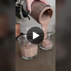 someone pouring chocolate into two small cups