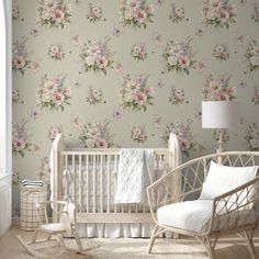 a baby's room with floral wallpaper and rocking chair in front of the crib