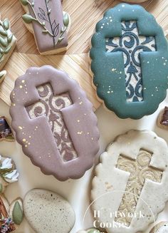 cookies decorated with different designs and colors on a table