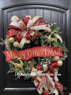 a christmas wreath on the front door with red and gold ribbon that says merry christmas