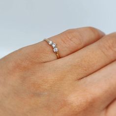 This beautiful dainty 14K Three Stone Pinky Ring is made out of 14K solid gold with sparkling simulated diamonds(CZ). It is the perfect size for a woman's pinky finger or a small ring finger. It can also be gifted to small girl or a baby.    * Genuine 14K gold  * Excellent Quality Cubic Zirconia Stones * Small dainty ring     If you're searching for a similar ring that's a bit bigger, we have a 5 stone option that's heavier and comes in both 14k yellow gold and 14K white gold. You can view the listings here:  14K yellow gold:  https://www.etsy.com/listing/1249553397/ 14k white gold:  https://www.etsy.com/listing/1235631154/ ▬  All jewelry pieces are sent in a gift box. ▬ Our shipping and return policies:  ~ Items will be shipped Free via USPS Ground Advantage. We gladly accept returns, exc Women Pinky Ring, Elegant Three Stone Birthstone Ring In 14k Gold, Dainty 14k Rose Gold Cluster Ring, Dainty Diamond Promise Ring With Birthstone, 14k Gold Cluster Ring With Round Cut For Promise, 14k Gold Round Cut Promise Cluster Ring, Dainty 14k Rose Gold Ring For Gift, 14k Rose Gold Birthstone Promise Ring, Dainty 14k Rose Gold Rings For Anniversary