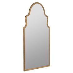 a large mirror sitting on top of a white wall