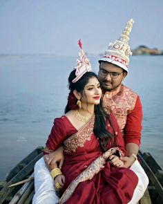 a man and woman sitting on top of a boat