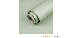 a roll of metallic foil on top of a white tablecloth next to a star