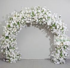 white flowers are arranged in the shape of an arch