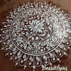 an intricately designed design on the ground in white and brown colors, with words below it