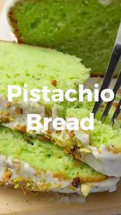 a close up of a piece of cake on a cutting board with a fork in it