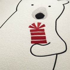 a polar bear with a gift box on it's back embroidered onto the side of a towel