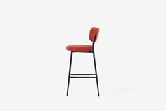 an orange bar stool with a black frame and backrest, against a white background