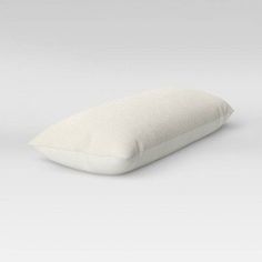 a white pillow sitting on top of a table