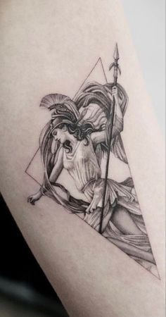 a black and white photo of a woman with an arrow tattoo on her thigh,