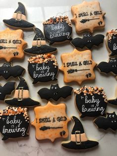 decorated cookies are arranged on a table for halloween party guests to enjoy and share their favorite treats