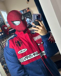 a person wearing a spider man costume taking a selfie