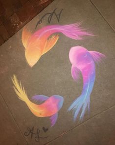 the sidewalk has been decorated with colorful fish and words on it, as well as graffiti