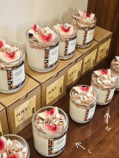 several desserts are arranged on top of each other in small containers and labeled with arrows