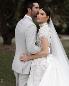 a bride and groom pose for a wedding photo