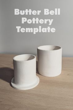 two white cups sitting on top of a wooden table next to each other with the words butter bell pottery template