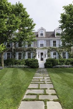 a large brick house with white trim and blue shutters is featured in the front cover of this magazine