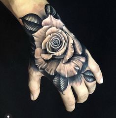 a person's hand with a tattoo on it and a rose in the middle