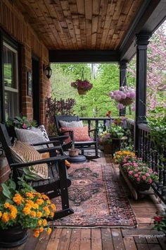 a porch with flowers and chairs on it