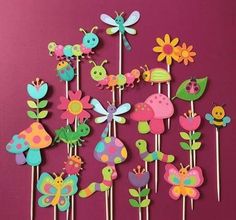 a bunch of cupcake toppers with flowers and bugs on them