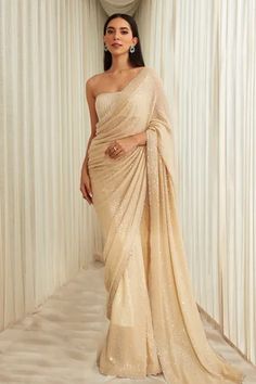 Beige ombre georgette saree with sequins embroidery. Comes with a padded blouse having cutdana embroidery and a petticoat.
Component: 3
Pattern: Embroidered
Type Of Work: Sequins, Cutdana
Sleeve Type: Sleeveless
Fabric: Georgette
Color: Beige
Other Details: 
Cutdana work on blouse
Occasion: Wedding - Aza Fashions Luxury Designer Wear Beige Saree, Luxury Beige Saree With Sheer Dupatta, Luxury Fitted Beige Saree, Luxury Cream Georgette Traditional Wear, Beige Indian Bridesmaid Dress, Luxury Beige Saree For Wedding, Luxury Beige Dress For Diwali, Luxury Designer Beige Saree, Saree Cape