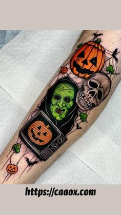 a person with a halloween themed tattoo on their arm