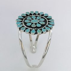 "This stunning Squash Blossom bracelet was handcrafted in Mexico. Each teardrop bezel is inlaid with turquoise coloured enamel enhanced with tiny brown flecks. Surrounding the centre blossom is a woven wire accent. The dimensions of the bracelet are approximately 8\" inches in circumference. This cuff can be adjusted down to 7\" and up to 8.5\" This piece is silver plated. The pattern of the enamel may vary very slightly, they are all individually hand crafted. If you've got any questions don't Southwestern Style Turquoise Cuff Bracelet, Southwestern Style Round Turquoise Cuff Bracelet, Southwestern Turquoise Bangle, Bohemian Turquoise Inlay Cuff Bracelet, Bracelet Mexican, Blossom Bracelet, Turquoise Squash Blossom, Navajo Style, Mexican Jewelry