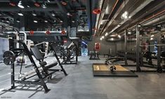 an empty gym with rows of exercise equipment