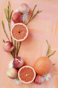 an arrangement of fruits and vegetables arranged in the shape of a letter o on a pink background