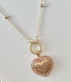 The Barbie Love Necklace is a stylish and endearing piece inspired by the necklace worn on Margot Robbie in the iconic Barbie Movie. Featuring a gold-filled heart shaped pendant surrounded by tiny pink gemstones on a dotted gold-filled chain, this necklace serves as a symbol of self love, positivity and the timeless appeal of Barbie. A perfect gift for anyone who adores Barbie or values the message of women empowerment. Available in multiple sizes