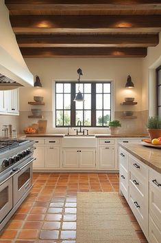 a large kitchen with white cabinets and tile flooring