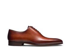 Part of our Magnanni Core Collection, the Cruz is a classic whole cut Oxford. Cut from a single piece of leather, it features a modern and slightly elongated toe box to create a sleek and elegant silhouette. This timeless design provides versatility to be worn for any occasion. Luxury Cognac Oxfords With Cap Toe, Luxury Cognac Cap Toe Oxfords, Luxury Plain Toe Oxfords In Cognac, Luxury Cognac Plain Toe Oxfords, Luxury Cognac Cap Toe Dress Shoes, Timeless Cognac Oxfords With Goodyear Welt, Luxury Brown Dress Shoes For Wedding, Luxury Cognac Oxfords For Semi-formal, Luxury Cognac Oxfords With Leather Lining