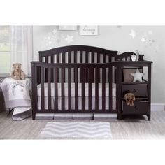 a baby crib in a room with stars on the wall