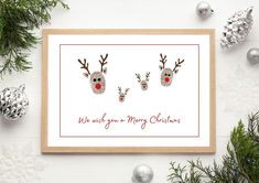 two reindeer heads with red noses are shown in this christmas card