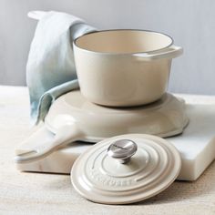 a white bowl sitting on top of a table next to a saucer and spatula