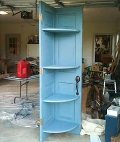 a blue shelf in the middle of a garage