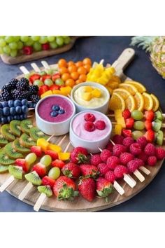 various fruits and dips arranged on a platter for a party or brunch