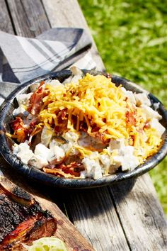 a bowl of food sitting on top of a wooden table