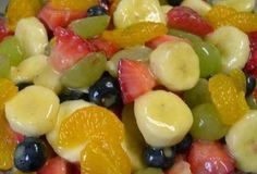 a glass bowl filled with fruit salad on top of a table