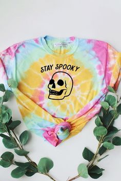 a tie dye shirt with a skull on it and the words stay spooky