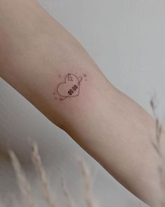 a small tattoo on the arm of a woman's left arm that says love