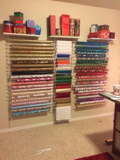 a room filled with lots of different types of fabrics on the wall next to a desk