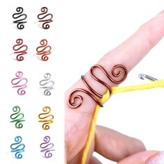 a hand holding a wire with the word love written on it and several colors in each