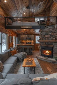 a living room filled with furniture and a fire place in the middle of a room