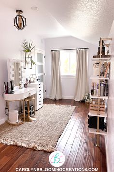 a white room with wooden floors and a large rug on the floor in front of a window